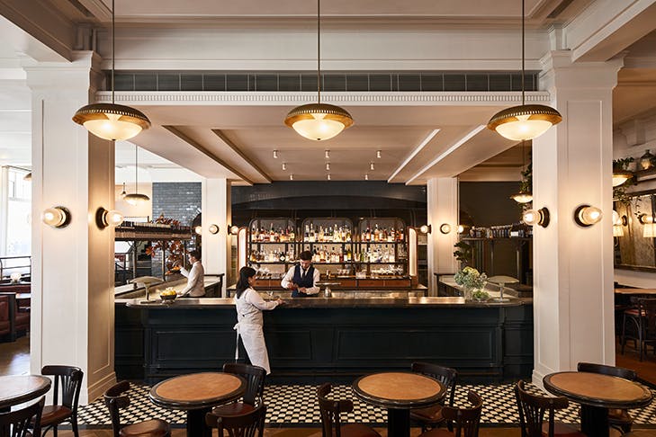 Gimlet's main bar adorned by two white pillars and filled with natural light.